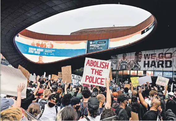  ?? Photo: Angela Weiss/afp ?? ‘We go hard’: Protesters at a Black Lives Matter march near the Barclays Center on May 29 in Brooklyn, New York. The writer has seen the advert in the background many times: at last she feels the image mirrors the aches of a city hidden under the smoke and mirrors.