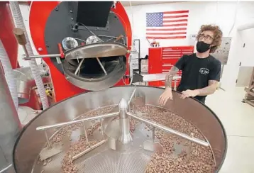  ?? FLORIDA SUN SENTINEL JOHN MCCALL/SOUTH ?? Chocolatie­r Tyler Levitetz works with cocoa beans Wednesday at 5150 Chocolate Co. in Delray Beach.