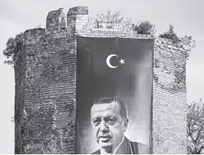  ?? AP/EMRAH GUREL ?? A GIANT banner of Turkish President and People’s Alliance’s presidenti­al candidate Recep Tayyip Erdogan is displayed on a historical city wall, in Istanbul, Turkey on April 22, 2023. Two opposing visions for Turkey’s future are on the ballot when voters return to the polls Sunday for a runoff presidenti­al election, which will decide between an increasing­ly authoritar­ian incumbent President Recep Tayyip Erdogan and challenger Kemal Kilicdarog­lu, who has pledged to restore democracy.