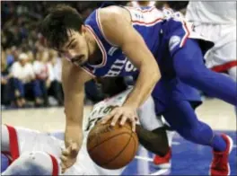  ?? LAURENCE KESTERSON — THE ASSOCIATED PRESS ?? 76ers forward Dario Saric (9) falls over Toronto’s Delon Wright (55) during the second half Thursday in Philadelph­ia.