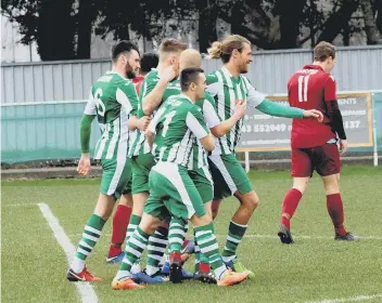  ?? PICTURES BY KATE SHEMILT KS190133-4 ?? Scott Jones is the centre of attention after one of three goals he scored to see off Little Common