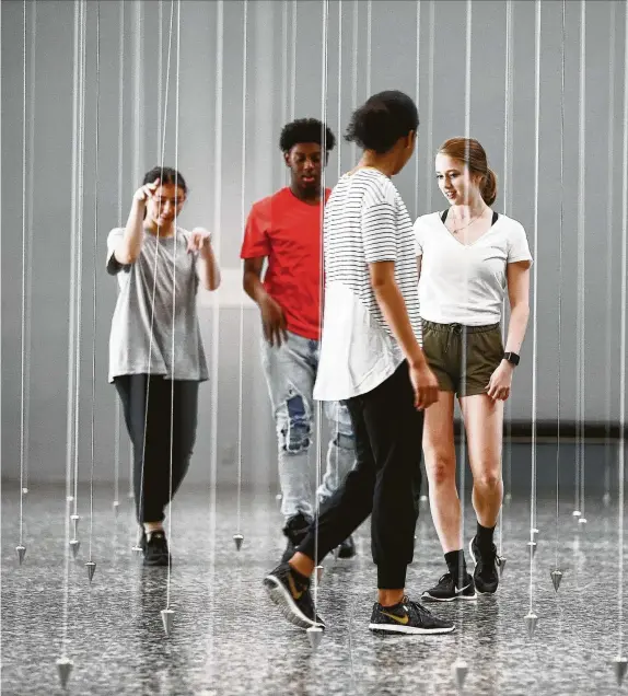  ?? Elizabeth Conley / Staff photograph­er ?? High Sschool for the Performing and Visual Arts dancers Chloe Madding, from left, Trevon Anderson, Kira Daniel and Nel Klimas interact with William Forsythe’s installati­on “Nowhere and Everywhere at the Same Time, No. 2” at the Museum of Fine Arts, Houston.