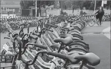  ?? WANG QIMING / FOR CHINA DAILY ?? A rider parks a shared bicycle at a parking lot earmarked for shared bikes in Nanjing, Jiangsu province, in October.