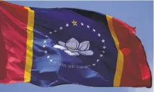  ?? Rogelio V. Solis / Associated Press ?? State voters approved the new flag’s design with a magnolia and the phrase “In God We Trust.”