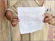  ?? PHOTOS: ABHISHEK SHUKLA ?? Suresh Kumar holds up a copy of the extortion letter that his brother received.