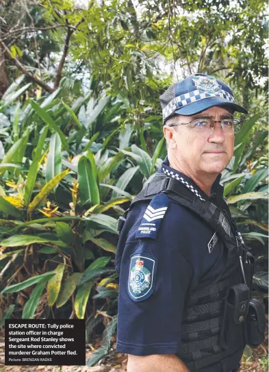  ?? Picture: BRENDAN RADKE ?? ESCAPE ROUTE: Tully police station officer in charge Sergeant Rod Stanley shows the site where convicted murderer Graham Potter fled.