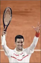  ?? Anne-christine Poujoulat / Getty Images ?? Novak Djokovic celebrates after his 6-0, 6-3, 6-2 third-round victory over Daniel Elahi Galan on Saturday at the French Open.