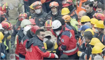  ?? — Reuters ?? Rescue workers carry a boy in a stretcher after they pulled him out from the rubble of a collapsed residentia­l building in Istanbul.