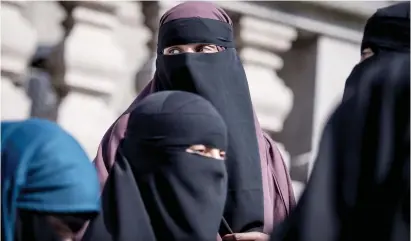  ?? Picture: AFP ?? DEFIANT. Women wearing the niqab exit the Danish Parliament in Copenhagen, Denmark, in May. The Danish parliament has passed a law banning the Islamic full-face veil in public spaces.