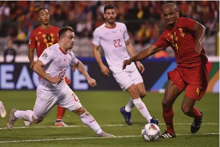  ?? AP ?? Switzerlan­d’s Xherdan Shaqiri ( left) vies for the ball with Vincent Kompany of Belgium during their UEFA Nations League football match at the King Baudouin Stadium in Brussels on Friday. Belgium won 2- 1. —