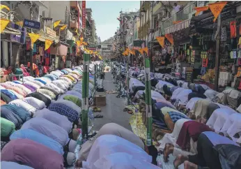  ??  ?? Muslims perform Friday prayers on a road in the north Indian town of Ajmer