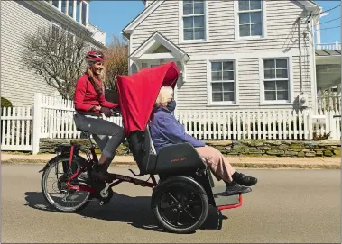  ?? DANA JENSEN/THE DAY ?? Alison Zach Darrell, a member of Bike Stonington, gives resident Mary-Loyd Brainard a ride Saturday on a Van Raam “Chats” trishaw, a power-assisted bike, around Stonington Borough. Members of Bike Stonington/Bike Groton were demonstrat­ing the trishaws Saturday in Groton and Stonington because they hope to purchase two trishaws and start a chapter of Cycling Without Age, a program that provides rides on trishaws for elderly and less mobile people.