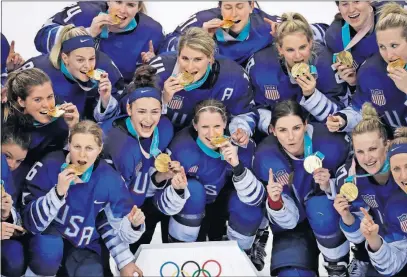  ?? [MATT SLOCUM/THE ASSOCIATED PRESS] ?? The United States players display their gold medals after beating Canada 3-2 in a shootout.
