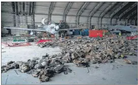  ?? AFP ?? Abandoned Afghan Air Force aircraft and armoured vests at the Kabul airport.