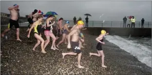  ??  ?? And there are off......Participan­ts brave the chill for the St Stephen’s Day Swim.