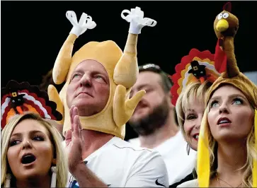  ?? Smiley N. Pool / Dallas Morning News /TNS ?? Dallas Cowboys fans wearthanks­giving-themed headgear during the first half an NFL football game against the Los Angeles Chargers in November 2017 at AT&T Stadium in Arlington,texas.