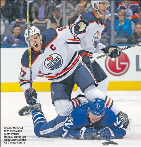  ?? CLAUS ANDERSEN/GETTY IMAGES ?? Connor McDavid trips over Maple Leafs’ Patrick Marleau during last night’s game at the Air Canada Centre.