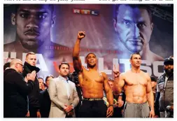  ??  ?? Anthony Joshua, left, and Wladimir Klitschko, right, together during the weigh-in event at Wembley in London on Friday ahead of their world heavyweigh­t title unificatio­n bout on Saturday. (AFP)