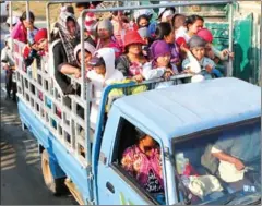  ?? PHA LINA ?? Garment factory workers stand inside a transport truck as they commute to their workplace in Phnom Penh’s Meanchey district.