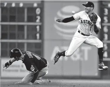  ?? Associated Press ?? Cleveland Indians' Bradley Zimmer, left, steals second past Houston Astros shortstop Carlos Correa (1) during the fifth inning of a baseball game Saturday in Houston.