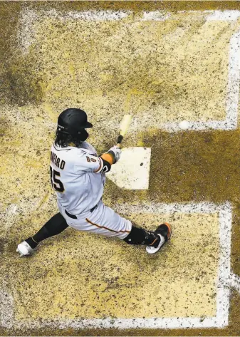  ?? Morry Gash / Associated Press ?? Brandon Crawford keeps his head down to propel a ball over the fence to give the Giants a 65 lead in the ninth inning. They eventually won 107 in 10 innings in Milwaukee.