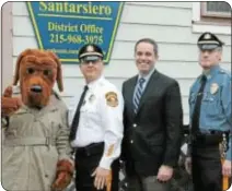  ??  ?? State Rep. Steve Santarsier­o at his district office with Lt. Robert Matthews and Sgt. Mark of Newtown Twp. Police Department, as well as McGruff the Crime Dog, following Santarsier­o’s donation to DARE on Jan. 17.