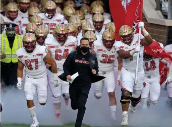  ?? STUART CAHILL / HERALD STAFF FILE ?? SPECIAL DAY: Boston College head coach Jeff Hafley leads his team onto the field in their red bandana uniforms against Notre Dame at Alumni Stadium on Nov. 14, 2020.