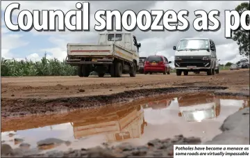  ?? ?? Potholes have become a menace as some roads are virtually impassable