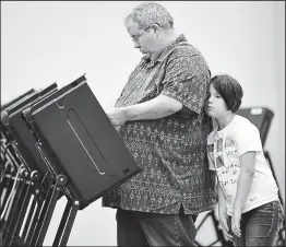  ?? FRED SQUILLANTE
DISPATCH ?? A not-too-enthused Lucia Murphy, 8, waits for Michael Murphy, her dad, to finish early voting on Wednesday at the Franklin County Board of Elections, 1700 Morse Rd.