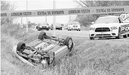  ?? Pascal Marchand / the cana dian press ?? A car is overturned in a ditch following an attack on soldiers at a plaza in Saint-Jean-sur-Richelieu, Que.