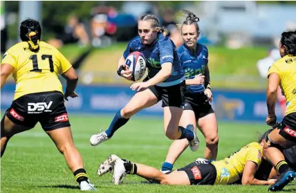  ?? Photo / Photosport ?? Blues first-five Krysten Cottrell looks for a gap in the Hurricanes Poua defence.