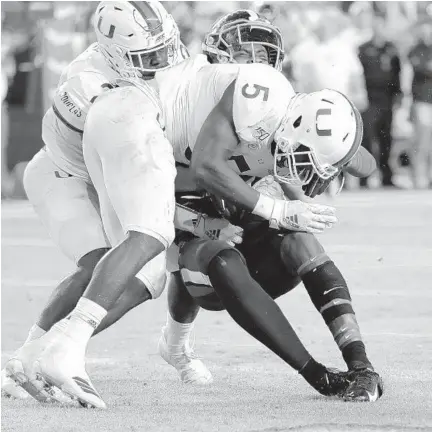  ?? LYNNESLADK­Y/AP ?? Miami safetyAmar­i Carterwas ejected fromthe gameafter this hit onVirginia wide receiver HasiseDubo­is.