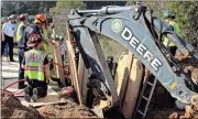  ?? Spencer Lahr / RN-T ?? Firefighte­rs work to rescue a man who had his lower body trapped inside a trench that was about 12 feet deep.