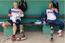  ??  ?? The Warriors prepping in the dugout. Sports and camaraderi­e “are now what give my life fulfillmen­t,” says a team member.