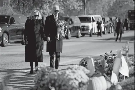  ?? EVAN VUCCI/AP PHOTO ?? President Joe Biden and first lady Jill Biden arrive at Schemengee­s Bar and Grille, one of the sites of last week’s mass shooting, to lay a bouquet of flowers Friday in Lewiston, Maine.