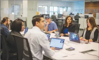  ?? SANDY CARSON / THE NEW YORK TIMES ?? Employers like Shamla Naidoo, second from left, global chief informatio­n security officer for IBM, and educators are rethinking the way they attract and train potential employees to meet the demands of an increasing­ly vulnerable online world.