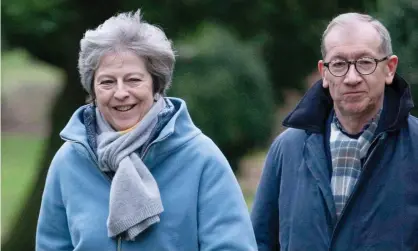  ?? Photograph: STRINGER/EPA ?? Theresa May goes to church with her husband in Maidenhead on Sunday.