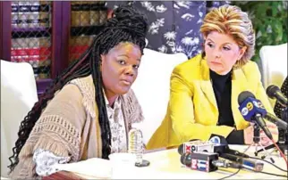  ?? MARK RALSTON/AFP ?? Essie Grundy (left) sits beside attorney Gloria Allred as they announce their race discrimina­tion lawsuit against retail giant Walmart in Los Angeles on Friday.