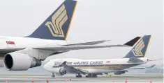  ?? REUTERS ?? A Singapore Airlines cargo jet taxis on the runway at the carrier’s hub, Changi airport. Global air freight is enjoying resurgent demand.