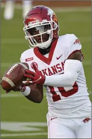  ?? (AP/Thomas Graning) ?? Arkansas receiver De’Vion Warren, shown warming up before last week’s victory over Mississipp­i State, said he has played in sloppy conditions like what the Razorbacks may face in Auburn, Ala., because of Hurricane Delta. “You’re slipping and sliding everywhere, and everybody’s just all over the place, getting stuck in the mud,” Warren said.