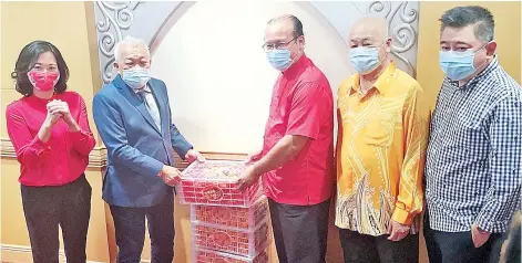  ??  ?? Bung Moktar (second left) presenting the Chinese New Year contributi­on to Lu (third left). Also seen are Pamela (left), Chin (fourth left) and Yong.