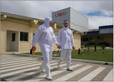  ?? (AP/Eraldo Peres) ?? Employees are seen on the grounds of a JBS plant in Lapa, Brazil, in this file photo.