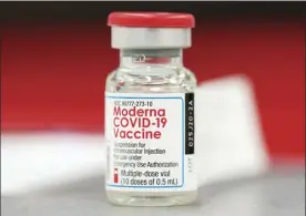  ?? AP file photo / David Zalubowski ?? A vial of the Moderna COVID-19 vaccine is shown in the first round of staff vaccinatio­ns at a hospital in Denver on Dec. 23. Federal regulators authorized the mixing and matching of COVID-19 booster shots this week in an effort to provide flexibilit­y for those seeking to maintain protection against the coronaviru­s. The announceme­nt by the Food and Drug Administra­tion came along with authorizat­ion for boosters of the Moderna and Johnson & Johnson shots.