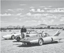  ?? GENERAL MOTORS ?? Legendary General Motors designer Harley Earl poses with three generation­s of the prototypic­al Firebird that were tested at the company’s Desert Proving Ground in the mid-1950s.