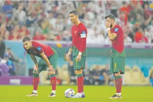  ?? ALESSANDRA TARANTINO/ASSOCIATED PRESS ?? Portugal’s Cristiano Ronaldo, center, stands with his teammates during the World Cup round of 16 match against Switzerlan­d on Tuesday in Lusail, Qatar.