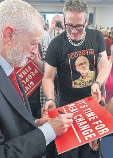  ??  ?? KEEPING THE FAN CLUB HAPPY: Britain’s main opposition Labour Party leader Jeremy Corbyn, left, meets supporters in Harlow, north of London, last week.