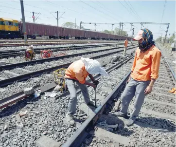  ?? — Reuters ?? A worker fixes a railway track in Ahmedabad, Gujarat.