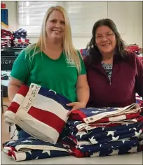  ?? ?? From left, Gina Weaver, Ukiah Shamrock 4-H Community Leader and VFW Post Commander CAPT DC USN ret Mary Anne Gonzalez working together on VFW flag project.