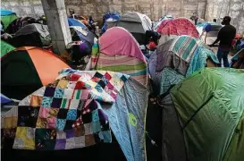  ?? ?? Dozens of tents serve as makeshift rooms for hundreds of migrants at Terraza Fandango shelter on Nov. 19 in Ciudad Acuña, Mexico, across from Del Rio.