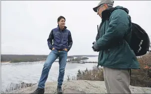  ?? CP PHOTO ?? Prime Minister Justin Trudeau talks with Sheldon Lambert, Conservati­on manager with Parks Canada, at the Landon bay in the Thousand Island National park in Gananoque, Ont., on Tuesday.